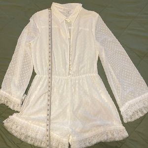 White romper with bell sleeves and lace trim